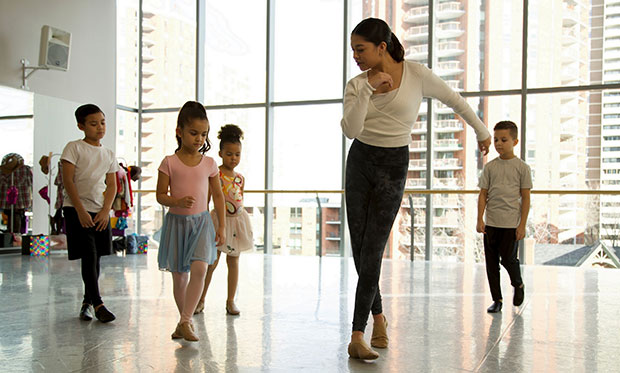 A dance teacher with young students