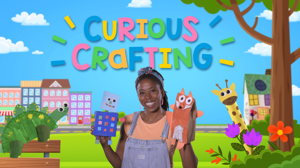 Host Mandisa Watts holding homemade puppets on a colourful blue background