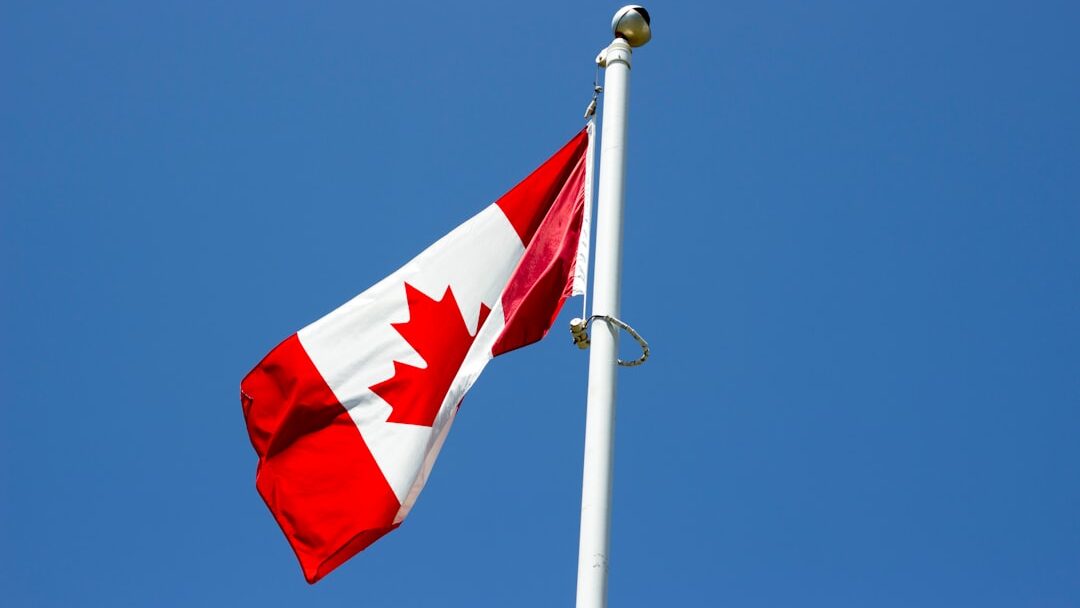 flag of Canada under blue sky at daytime