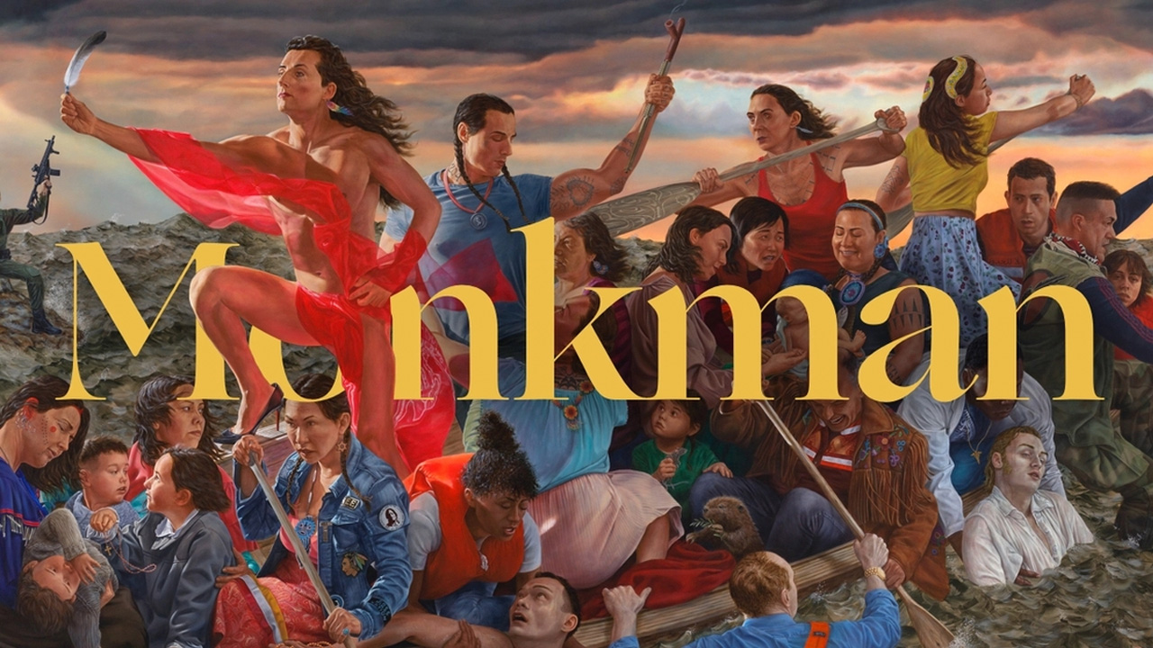 A detailed painting shows a large group of people gathered near water under a dramatic sky, with several individuals paddling canoes and others standing or sitting closely together. The word “Monkman” appears prominently across the center in large gold letters.